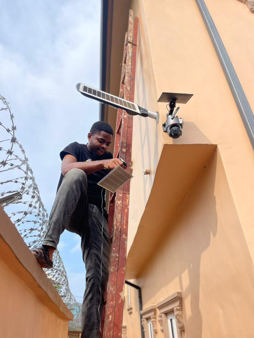 Keltalz technician installing CCTV and solar street light on a building